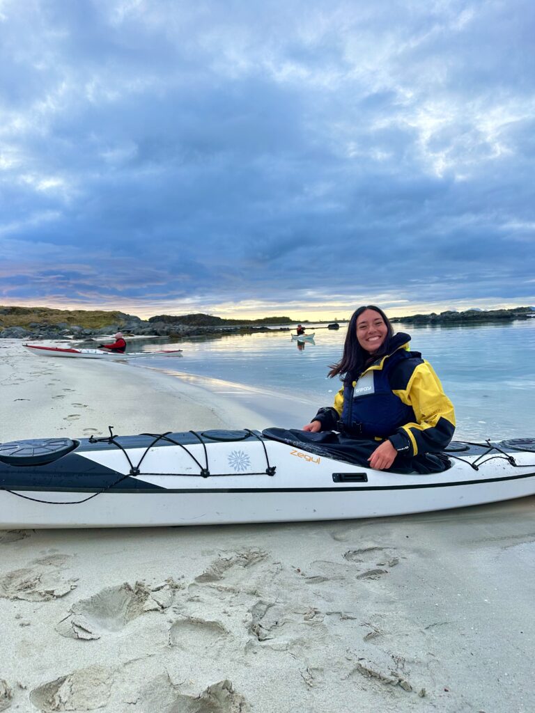 Happy woman on a kayak tour in Lofoten